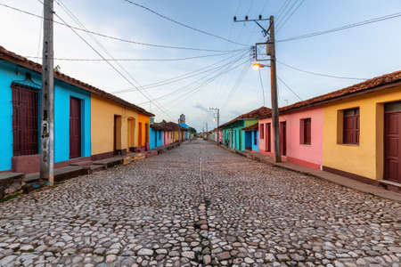 Street view of a Residential neighborhood in a small Cuban Town during a cloudy and sunny sunrise. Taken in Trinidad, Cuba.の写真素材