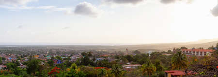 Aerial Panoramic view of a small touristic Cuban Town during a colorful and cloudy sunset. Taken in Trinidad, Cuba.の写真素材