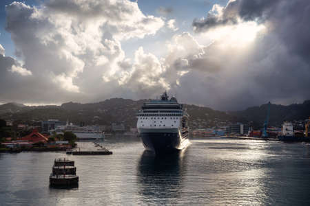 Castries, Saint Lucia. View of a Big Luxurious Cruise Ships docked in a port during a cloudy and colorful morning sunrise.の写真素材