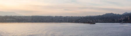 Nanaimo, Vancouver Island, British Columbia, Canada. Panoramic View of Residential Homes in the Modern City by the Ocean during a colorful sunset.の写真素材