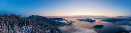 Aerial Panoramic View of Canadian Mountain Landscape on the Pacific Ocean Coast during a colorful sunset. Taken in Howe Sound near Vancouver, British Columbia, Canada.の写真素材