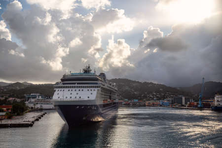 Castries, Saint Lucia - December 3, 2019: View of a Big Luxurious Cruise Ships docked in a port during a cloudy and colorful morning sunrise.のeditorial素材