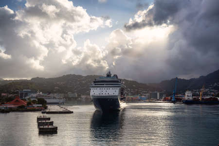 Castries, Saint Lucia - December 3, 2019: View of a Big Luxurious Cruise Ships docked in a port during a cloudy and colorful morning sunrise.のeditorial素材