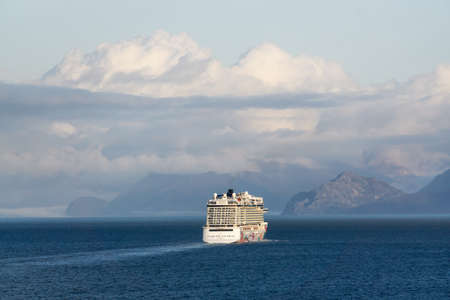 Glacier Bay National Park and Preserve, Alaska, USA - September 25, 2019: Norwegian Cruise Ship is cuising in the Ocean during a cloudy and sunny morning in fall season.のeditorial素材
