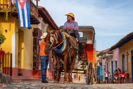 Trinidad, Cuba - June 12, 2019: Horse Carriage in the streets of a small Cuban Town during a vibrant and colorful sunset.のeditorial素材