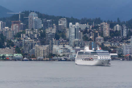 Downtown Vancouver, British Columbia, Canada - September 21, 2019: Boats and Ships in Vancouver Harbour during a cloudy evening.のeditorial素材