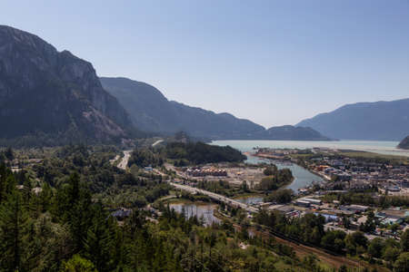 Aerial view of residential homes in a small town with Chief Mountain in the background during a sunny summer day. Taken in Squamish, North of Vancouver, British Columbia, Canada.の写真素材