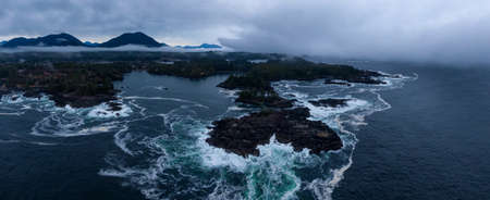 Ucluelet, Vancouver Island, British Columbia, Canada. Aerial Panoramic View of a Small Town near Tofino on a Rocky Pacific Ocean Coast during a cloudy sunrise.の写真素材
