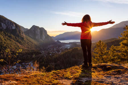 Adventurous Girl Hiking in the mountains during a sunny Autumn Sunset. Taken Squamish, North of Vancouver, British Columbia, Canada. Concept: Adventure, freedom, lifestyleの写真素材