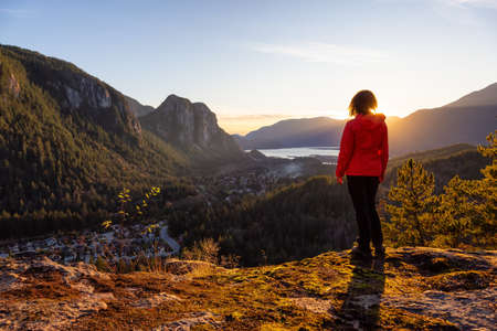 Adventurous Girl Hiking in the mountains during a sunny Autumn Sunset. Taken Squamish, North of Vancouver, British Columbia, Canada. Concept: Adventure, freedom, lifestyleの写真素材