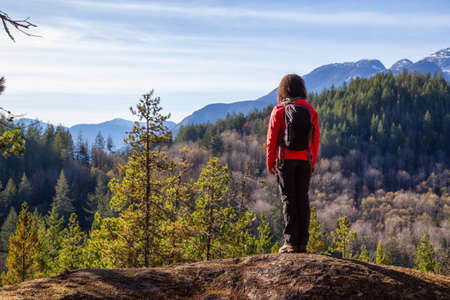 Adventurous Girl Hiking in the mountains during a sunny Autumn Evening. Taken Squamish, North of Vancouver, British Columbia, Canada.の写真素材