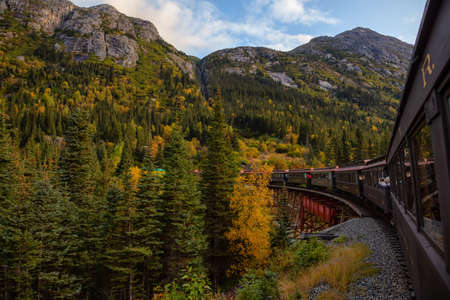 Skagway, Alaska, United States - September 24, 2019: Old Historic Railroad Train is going over a...