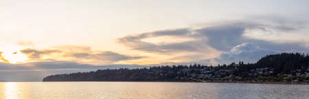 White Rock, British Columbia, Canada. Beautiful Panoramic View of Residential Homes on the Ocean Shore during a sunny and cloudy summer sunset.の写真素材
