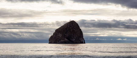 Pacific City, Oregon, United States of America. Beautiful Panoramic View of Chief Kiawanda Rock on the Ocean Coast during a cloudy summer evening.の写真素材