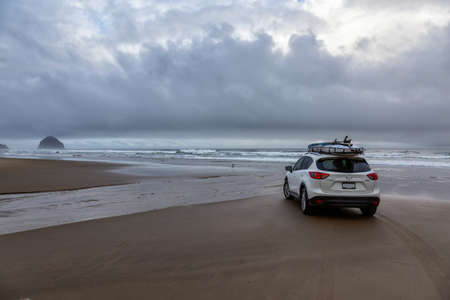 Pacific City, Oregon, United States of America. September 8, 2019: Mazda CX-5 riding on the sandy beach at the Ocean Coast during a cloudy summer sunrise.のeditorial素材