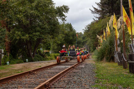Rockaway Beach, Oregon, United States of America - September 7, 2019: Group of people Railbiking on the rail road tracks.のeditorial素材