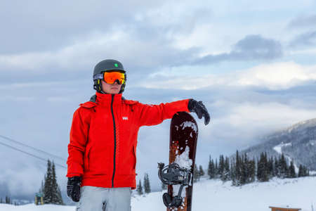 Whistler, British Columbia, Canada - December26, 2019: Male Snowboarder is riding down a ski run in wintertime.のeditorial素材