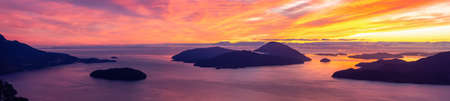 Tunnel Bluffs Hike, in Howe Sound, North of Vancouver, British Columbia, Canada. Panoramic Canadian Mountain Landscape View from the Peak during sunny winter sunset.の写真素材