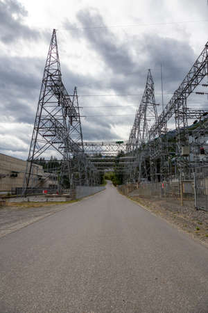 View of a Road going underneath an Electrical Station by Seton Lake during a cloudy summer day....