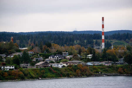 Campbell River, Vancouver Island, British Columbia, Canada. Beautiful view of residential homes on the ocean shore during a cloudy evening.の写真素材