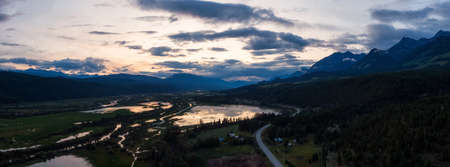 Aerial Panoramic View of a Scenic Road in a Beautiful Canadian Landscape during a colorful summer sunset. Taken in Kootenay near Golden, British Columbia, Canada.の写真素材