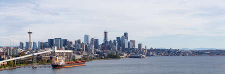 Downtown Seattle, Washington, United States of America. Aerial Panoramic View of the Modern City on the Pacific Ocean Coast during a sunny and cloudy Autumn Day.の写真素材