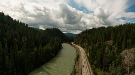 Aerial Panoramic View of a Scenic Highway in the Valley surrounded by Canadian Mountain Landscape. Taken near Clearwater, North of Kamloops, British Columbia, Canada.の写真素材