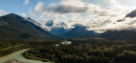 Aerial Panoramic View of Beautiful Canadian Mountain Landscape during a sunny and cloudy summer sunrise. Taken near Mt Robson, British Columbia, Canada.の写真素材