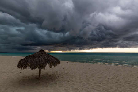 Beautiful view of a sandy beach in Varadero, Cuba, on the Caribbean Sea. Taken during a dark,...