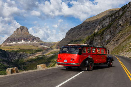 Glacier National Park, Montana, United States - September 1, 2019: Tour Bus riding on a scenic road...