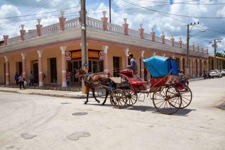 Ciego de Avila, Central Cuba - June 14, 2019: Urban Street view of a small Cuban Town during a cloudy and sunny summer day.のeditorial素材