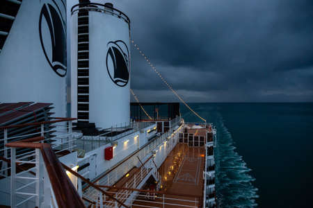 Glacier Bay National Park and Preserve, Alaska, USA - September 25, 2019: Holland America Line Cruise Ship in cuising in the Ocean during a cloudy and colorful sunrise in fall.のeditorial素材
