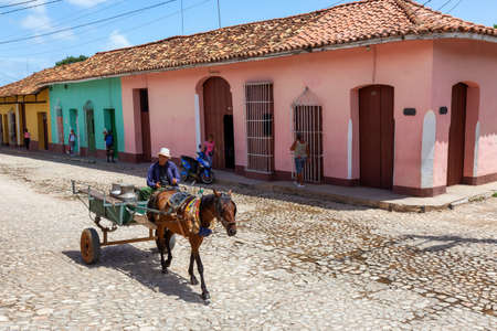 Trinidad, Cuba - June 08, 2019: Horse Riding in the Streets of a small Cuban Town during a vibrant sunny day.のeditorial素材