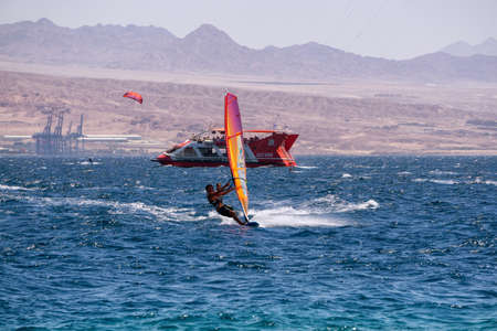 Eilat, Israel - April 12, 2019: Adventurous People are enjoying water sports, Windsurfing and...