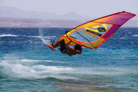 Eilat, Israel - April 12, 2019: Adventurous Man is enjoying water sports, Windsurfing, in the Red Sea during a sunny day.のeditorial素材