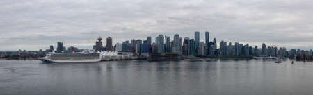 Vancouver, British Columbia, Canada - September 21, 2019: Beautiful Panoramic View of Downtown City, Canada Place and Coal Harbour during a cloudy summer evening.のeditorial素材