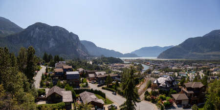 Panoramic view of residential homes in a small town with Chief Mountain in the background during a sunny summer day. Taken in Squamish, North of Vancouver, British Columbia, Canada.の写真素材