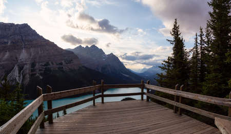 Canadian Rockies and Peyto Lake viewed from the top of a mountain during a vibrant summer sunset....