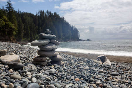 Stack of Rocks on a rocky coast along the Juan de Fuca Trail during a sunny and cloudy summer day. Taken at Sombrio Beach, near Port Renfrew, Vancouver Island, BC, Canada.の写真素材