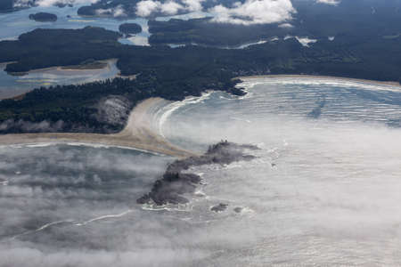 Aerial view of beautiful Beach on the Pacific Ocean Coast during a sunny summer morning. Taken in...