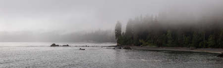Beautiful Panoramic View of a rocky beach on the Juan de Fuca Trail during a summer sunset. Taken at...