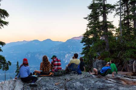 Squamish, British Columbia, Canada - August 20, 2016: A group of friends are enjoying a beautiful view from the mountain during a summer sunset.のeditorial素材
