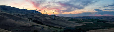 Beautiful Panoramic Landscape View of Wind Turbines on a Windy Hill during a colorful sunrise. Taken in Washington State, United States of America.の写真素材