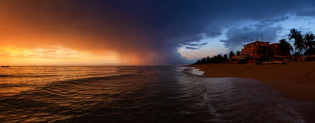 Beautiful panoramic view of vacation resort on the sandy beach during a dramatic cloudy sunset. Taken in Varadero, Cuba.の写真素材