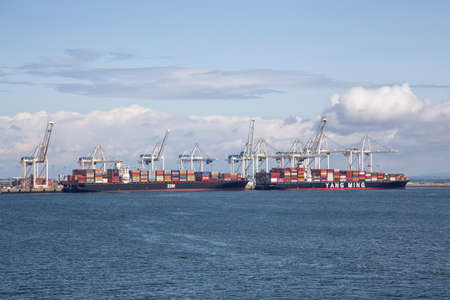 Tsawwasen, Greater Vancouver, BC, Canada - July 14, 2019: Big Container ships are being loaded at...