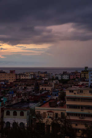 Aerial view of the residential neighborhood in the Havana City, Capital of Cuba, during a colorful and rainy sunset.の写真素材