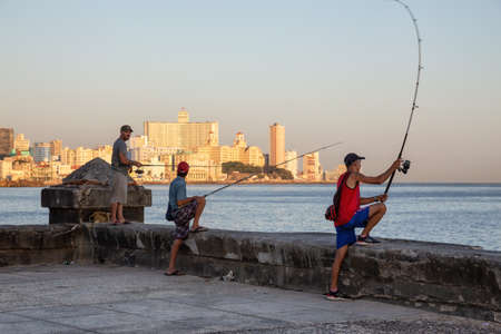 Havana, Cuba - May 21, 2019: Cuban people are fishing in the ocean during a sunny morning sunrise, taken during the Shortage of Food Crisis.のeditorial素材
