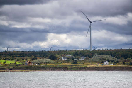 Wind Turbine on the ocean coast during a cloudy day. Taken in New Victoria, Nova Scotia, Canada.