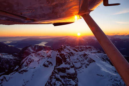 View from the small airplane flying over the Beautiful Canadian Mountain Landscape during vibrant...