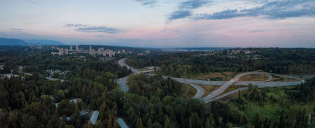 Aerial panoramic view of a highway entrance and exit in the modern city during a vibrant summer...